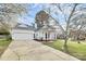 Inviting one-story home boasting a spacious driveway, attached garage, and manicured lawn at 2702 Robyns Glen Dr, Charlotte, NC 28269