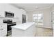 Bright kitchen featuring an island, stainless steel appliances, and white cabinetry at 2702 Robyns Glen Dr, Charlotte, NC 28269