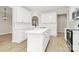 Bright kitchen with white cabinetry, island, and stainless steel appliances at 2702 Robyns Glen Dr, Charlotte, NC 28269