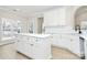 Modern kitchen with an island, white cabinets and stainless steel appliances at 2702 Robyns Glen Dr, Charlotte, NC 28269