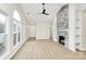 Bright living room with clean floors, a stone fireplace, built-in shelves, and large arched windows at 2702 Robyns Glen Dr, Charlotte, NC 28269
