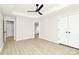 Spacious main bedroom featuring tray ceilings, fan, and light wood-look flooring at 2702 Robyns Glen Dr, Charlotte, NC 28269