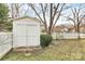 Outdoor shed in a fenced-in yard, surrounded by well-maintained landscaping and mature trees, with lots of storage at 2702 Robyns Glen Dr, Charlotte, NC 28269