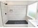 Tiled walk-in shower with black hardware and hexagon tile flooring at 2702 Robyns Glen Dr, Charlotte, NC 28269