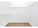 Walk-in closet with wire shelving and light wood-look flooring at 2702 Robyns Glen Dr, Charlotte, NC 28269
