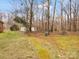 Serene backyard with mossy grass, mature trees and detached garage at 308 Wellington Dr, Matthews, NC 28104