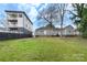 A spacious fenced backyard with grass and mature trees providing ample outdoor living space at 312 Flint St, Charlotte, NC 28216
