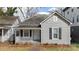 Charming home featuring a covered porch and gray siding at 312 Flint St, Charlotte, NC 28216