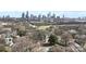 A high angle shows an urban area with houses under trees and the city skyline at 314 Flint St, Charlotte, NC 28216