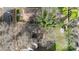 Aerial view of a backyard featuring lush grass, mature trees, and a storage shed at 314 Flint St, Charlotte, NC 28216