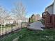 A beautifully landscaped backyard with stone terrace and wrought iron fencing at 315 Drake Park Ave, Fort Mill, SC 29708