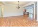 Spacious dining area with hardwood floors and a chandelier, open to a kitchen and living area for easy entertaining at 315 Drake Park Ave, Fort Mill, SC 29708