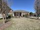 Traditional brick home with a well-maintained lawn and mature trees, creating a serene and inviting curb appeal at 315 Drake Park Ave, Fort Mill, SC 29708
