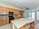Bright kitchen with wood cabinets, granite countertops, and stainless steel appliances at 315 Drake Park Ave, Fort Mill, SC 29708