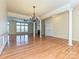 Elegant living room with hardwood floors, a chandelier, and a view into other living spaces, perfect for gatherings at 315 Drake Park Ave, Fort Mill, SC 29708