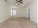 Spacious main bedroom featuring carpet floors, modern ceiling fan and tray ceilings at 315 Drake Park Ave, Fort Mill, SC 29708