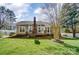 Lovely home's backyard with lawn, deck and mature trees at 3200 Tallia Ct, Charlotte, NC 28269