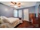 Bedroom showcasing neutral walls, wood-look floors, and a wooden ceiling fan at 3200 Tallia Ct, Charlotte, NC 28269