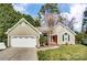 Charming single-Gathering home featuring a landscaped front yard, two-car garage, and inviting red front door at 3200 Tallia Ct, Charlotte, NC 28269