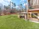 Exterior backyard featuring a covered outdoor kitchen, gazebo, and well-manicured grass at 3449 Southern Red Oak Ln, Gastonia, NC 28056
