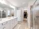 This full bathroom features a large double sink vanity, a glass shower, and a walk-in closet at 3449 Southern Red Oak Ln, Gastonia, NC 28056