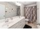 This bathroom features double sinks, and decorative tiling in the shower and mirror at 3449 Southern Red Oak Ln, Gastonia, NC 28056