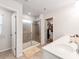A full bathroom featuring a glass shower, walk-in closet, and single sink vanity at 3449 Southern Red Oak Ln, Gastonia, NC 28056