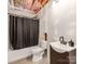 Finished basement bathroom with a shower, black shower curtain, toilet, and dark brown sink at 3449 Southern Red Oak Ln, Gastonia, NC 28056