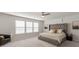 This primary bedroom offers a large bed with a tufted headboard and lots of natural light at 3449 Southern Red Oak Ln, Gastonia, NC 28056