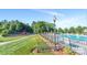 The community amenities including a playground and pool with mature trees and seating areas are available to residents at 3449 Southern Red Oak Ln, Gastonia, NC 28056