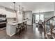Open-concept kitchen with white cabinets, stainless steel appliances, and a spacious island with bar seating at 3449 Southern Red Oak Ln, Gastonia, NC 28056