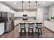 Modern kitchen with white cabinets, stainless steel appliances, and a center island with stylish pendant lighting at 3449 Southern Red Oak Ln, Gastonia, NC 28056