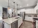 Bright kitchen with white cabinets, stainless steel appliances, and a large island with seating and modern fixtures at 3449 Southern Red Oak Ln, Gastonia, NC 28056