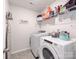 Convenient laundry room with modern washer and dryer, and additional shelving space at 3449 Southern Red Oak Ln, Gastonia, NC 28056