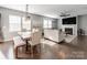 Open-concept living and dining area with hardwood floors, fireplace, and ample natural light at 3449 Southern Red Oak Ln, Gastonia, NC 28056