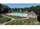 A refreshing community pool surrounded by mature trees and featuring ample seating for residents to enjoy at 3449 Southern Red Oak Ln, Gastonia, NC 28056
