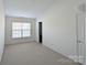 Bright bedroom featuring neutral carpet, a large window, and white walls, offering a cozy and inviting space at 3812 York Aly, Lake Park, NC 28079