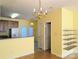 Eat-in kitchen with wood cabinets, white appliances, a tiled floor, and a chandelier at 3812 York Aly, Lake Park, NC 28079