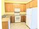 Efficient kitchen with white appliances and wood cabinets, offers an abundance of storage space at 3812 York Aly, Lake Park, NC 28079