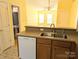 Open kitchen with a view to the living space featuring updated appliances, a bar, and a modern faucet at 3812 York Aly, Lake Park, NC 28079