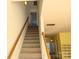 Carpeted staircase leading to the upper level of the home, featuring a light wood railing and white walls at 3812 York Aly, Lake Park, NC 28079