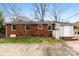 Back exterior of brick home with concrete patio and yard, providing a functional outdoor space at 3918 Woodgreen Ter, Charlotte, NC 28205