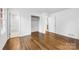 A well-lit bedroom with hardwood floors, white walls, closet, and ample doorway space at 3918 Woodgreen Ter, Charlotte, NC 28205