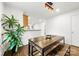Open dining room featuring modern lighting, a dining table with benches, and a large plant at 3918 Woodgreen Ter, Charlotte, NC 28205