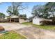 Exterior view of a single story home featuring a carport and detached garage at 3918 Woodgreen Ter, Charlotte, NC 28205