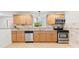 Bright kitchen with stainless steel appliances, light wood cabinets, and tile flooring at 3918 Woodgreen Ter, Charlotte, NC 28205