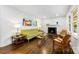 Bright living room featuring a fireplace, hardwood floors, and modern decor at 3918 Woodgreen Ter, Charlotte, NC 28205