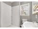 Bathroom with a tiled shower, toilet, and vanity area with a window at 428 Chester St, Lancaster, SC 29720