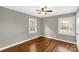 Bedroom featuring hardwood floors, two windows, a ceiling fan, and neutral wall paint at 428 Chester St, Lancaster, SC 29720
