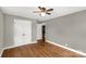 Bedroom with hardwood floors, a closet, grey walls, white trim, and a ceiling fan at 428 Chester St, Lancaster, SC 29720